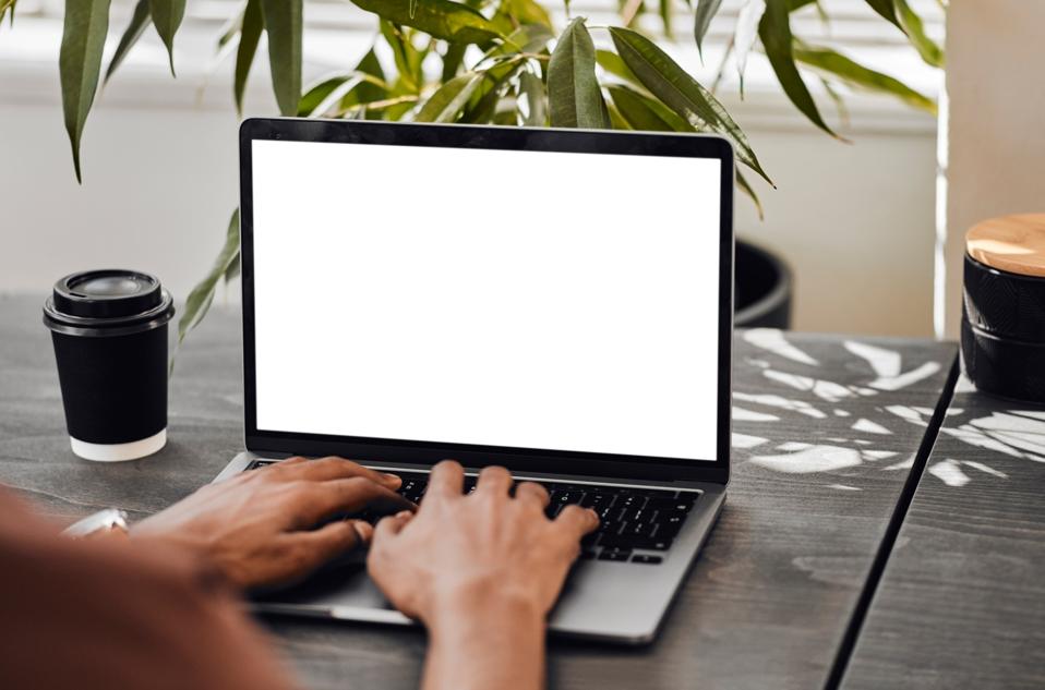 Mock up space, laptop with hand of businessman remote work on digital, marketing or email in restaurant cafe. Planning, search and coffee with tech for internet, network and web design on screen