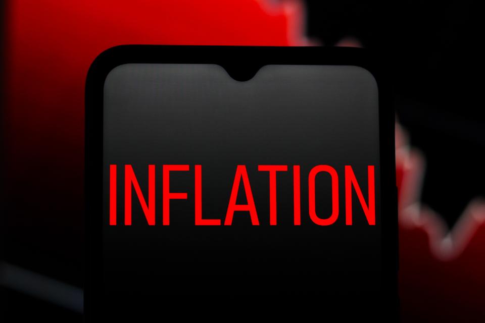 In this photo illustration, Inflation text is seen displayed...