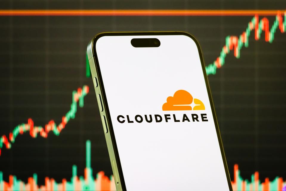Cloudflare Inc. logo displayed on smartphone screen with stock chart in background
