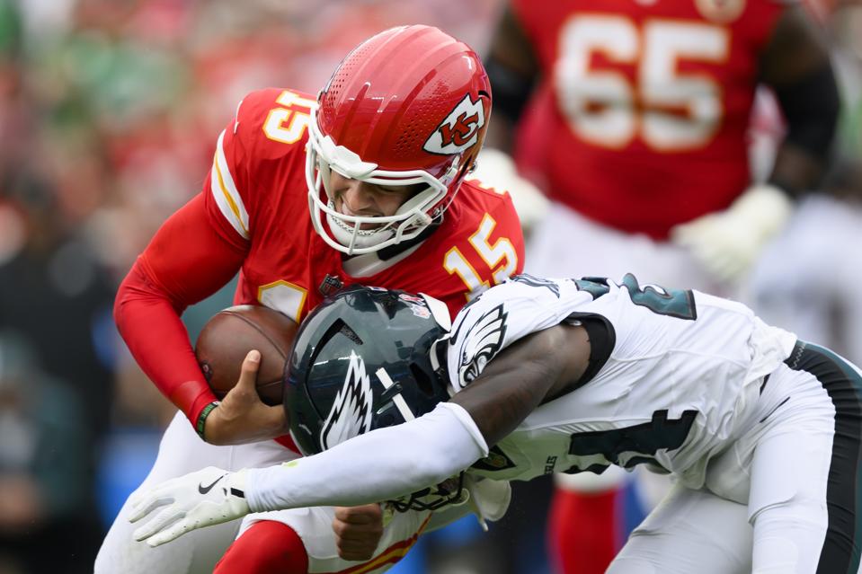 Patrick Mahomes runs over Andrew Mukuba.