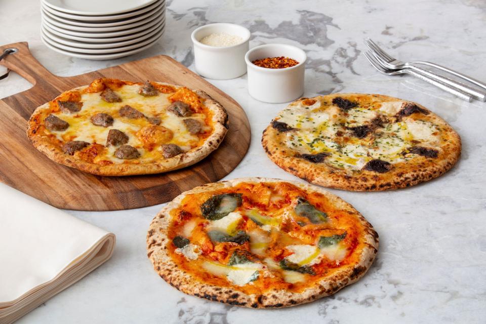 three fresh baked artisan pizzas