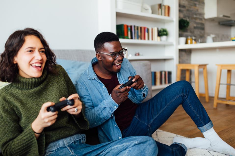 Happy young diverse couple relaxing at home