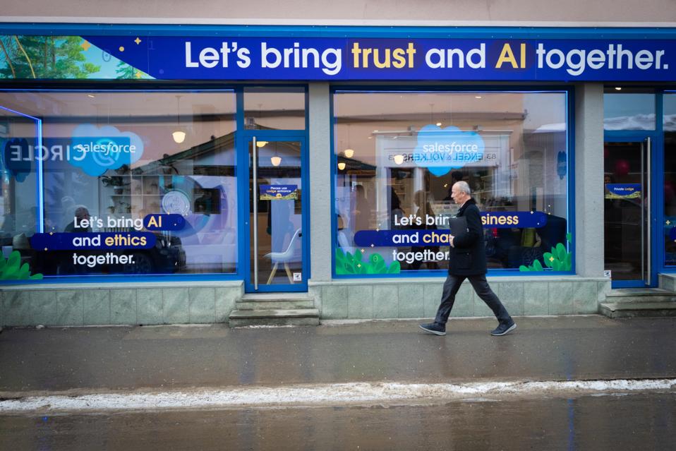 A person walks past a temporary AI stall along the main promenade at the WEF