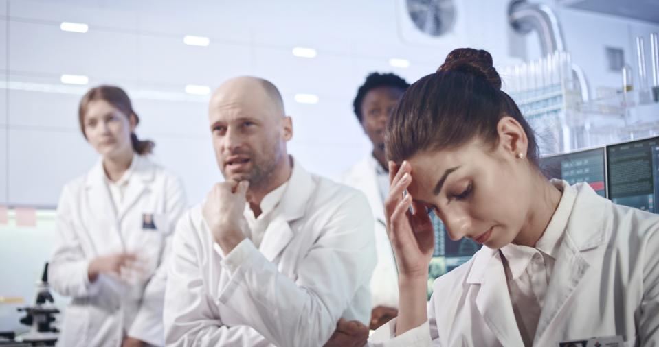 Multi ethnic laboratory team devastated by the research result