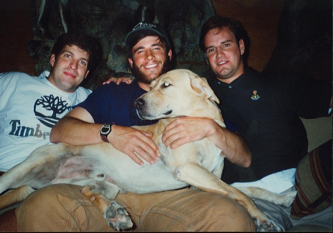 Craig Silvey, Todd Graves, and an unknown person on a couch with a dog.