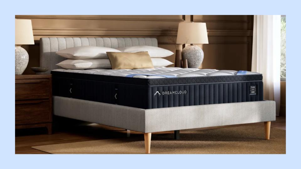 Photo of DreamCloud Premier Hybrid Mattress on a gray bed frame in a modern bedroom. 