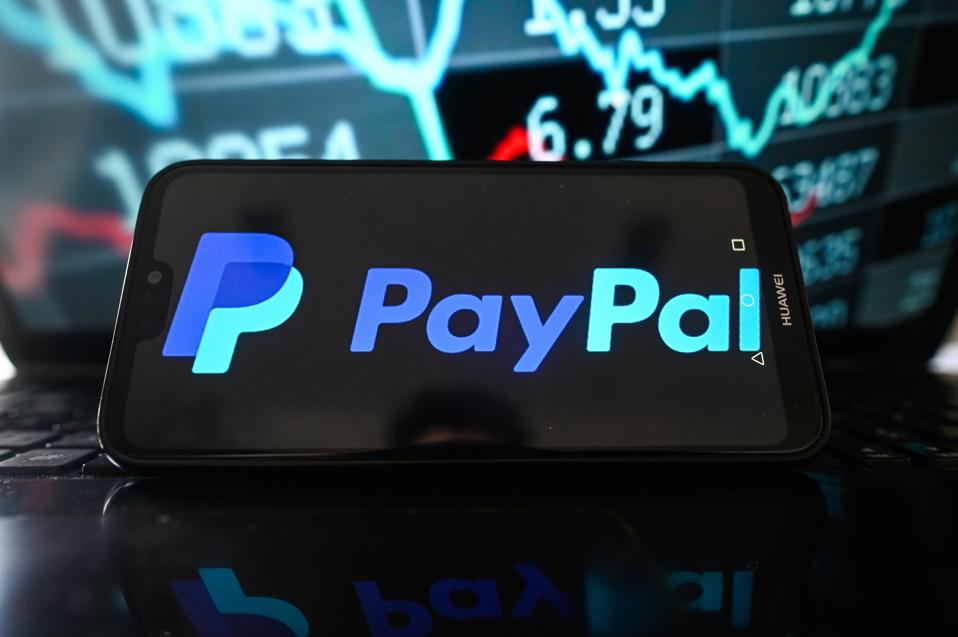 In this photo illustration, a Paypal logo is seen displayed...