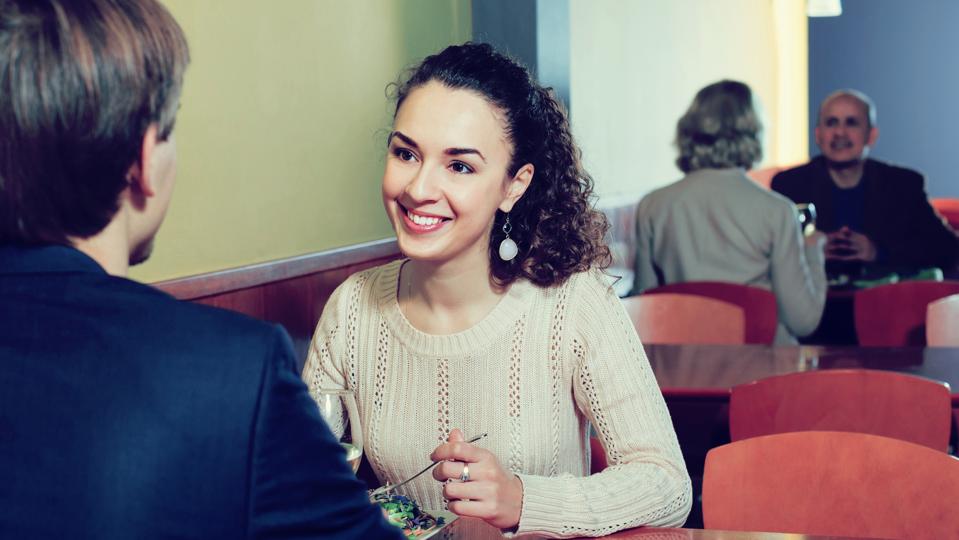 Man and woman chatting as having date