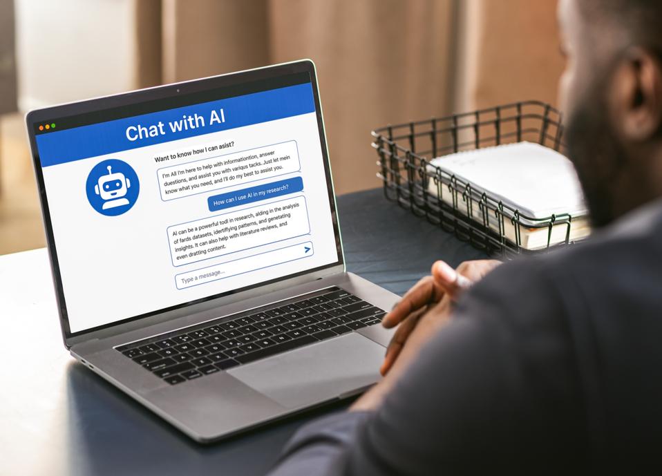 Man using an AI chatbot on a laptop, representing the role of ChatGPT in promotions.