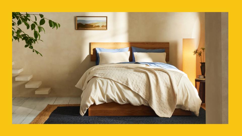 Photo of Brooklinen bed on a yellow background. 