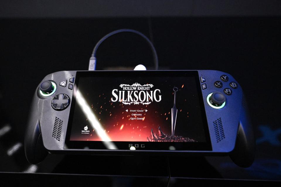 The ROG Xbox Ally X from ASUS and Xbox with Hollow Knight: Silksong displayed onscreen.