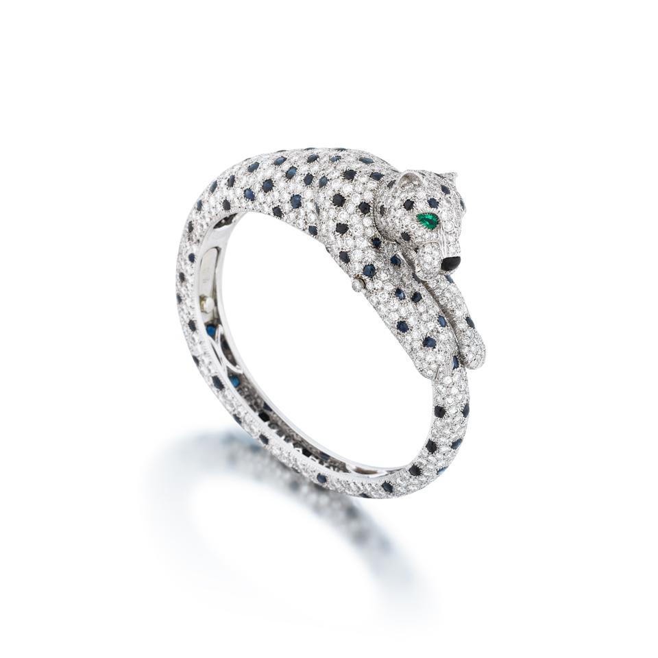 Cartier Panthere bangle with sapphire spots, diamonds, emerald eyes and onyx nose. 