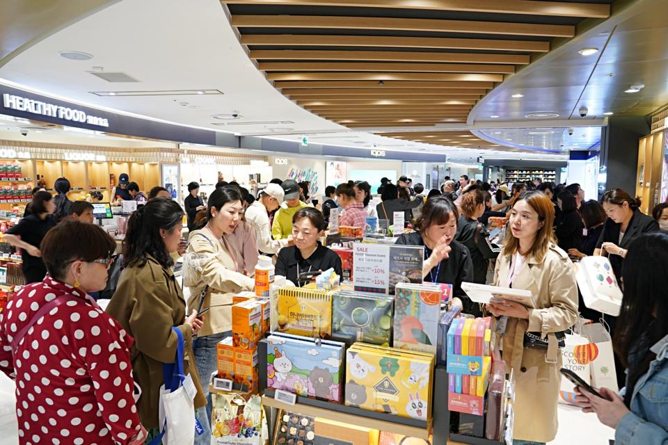 Chinese shoppers in a crowded Lotte Duty Free store