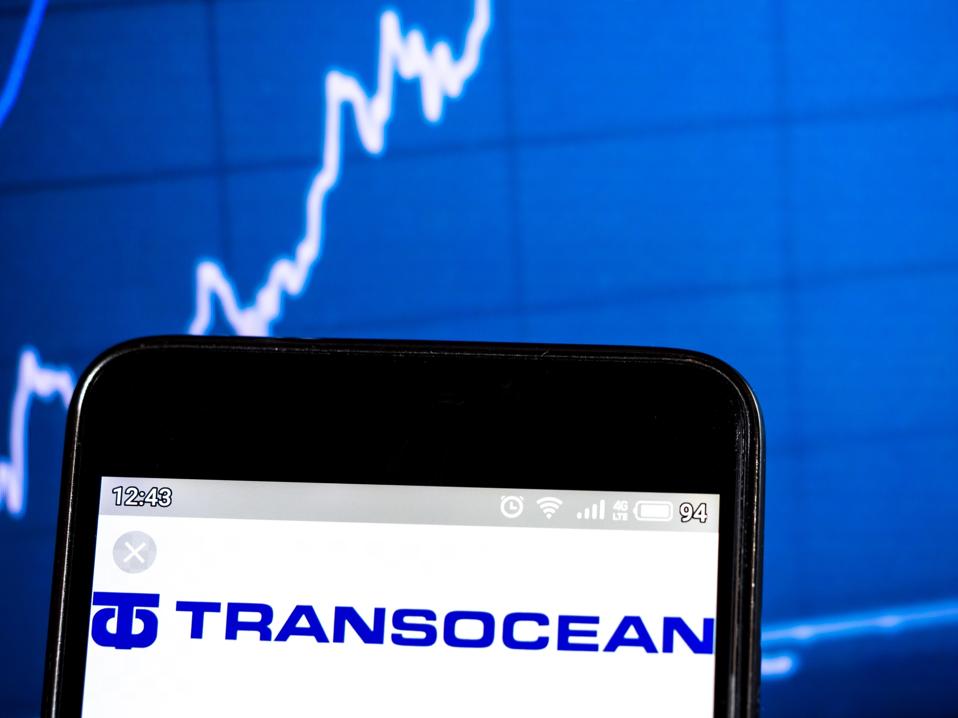 In this photo illustration a Transocean Ltd logo seen...