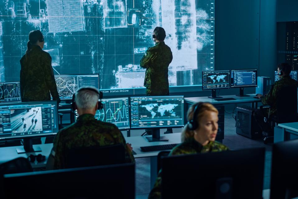 Military Surveillance Team of Officers Locked a Target on a Vehicle from a Satellite and Monitor it on a Big Display in Office for Cyber Operations for Managing Security and Army Communications.