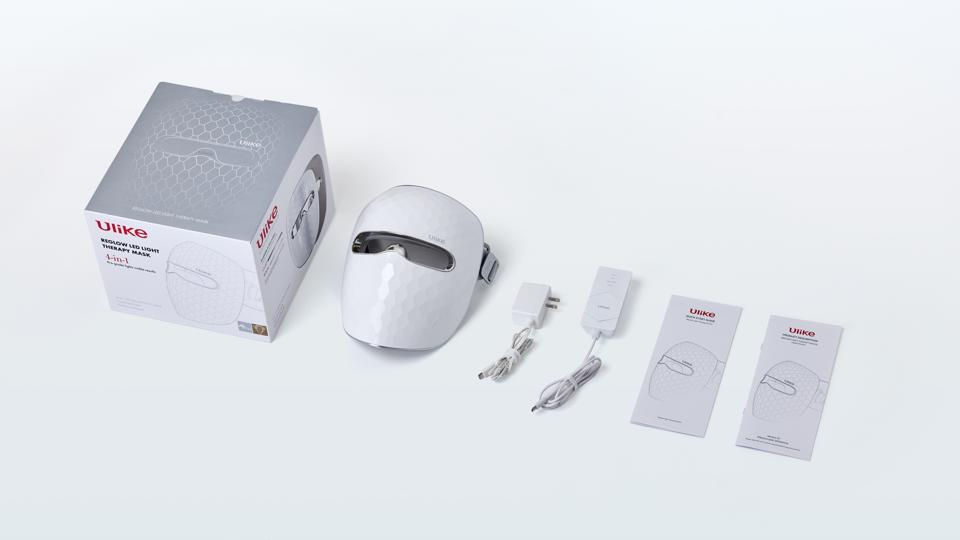 Ulike ReGlow LED Face Mask, box, cords, and manual against white background.