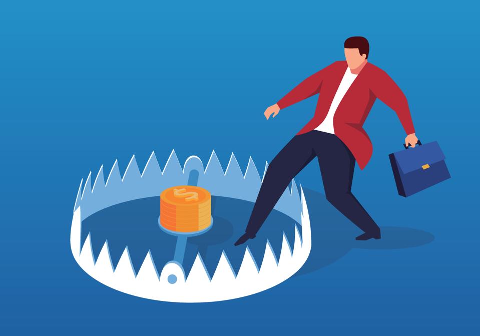 Businessman carefully enters mouse trap
