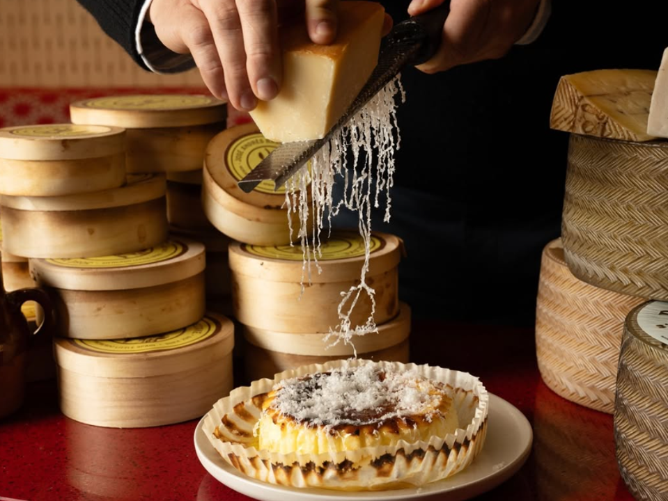 The Basque cheesecake cart at Txula Steak offers a variety of cheeses to grate on top of dessert