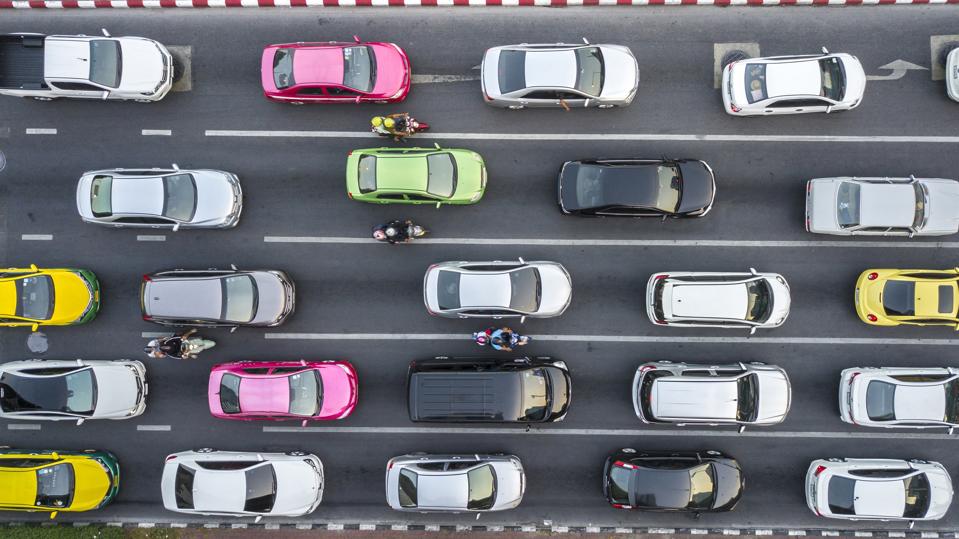 Aerial view of cars in rush hour traffic, symbolizing the return of commuting alongside new patterns of flexible work hours and midweek office routines.