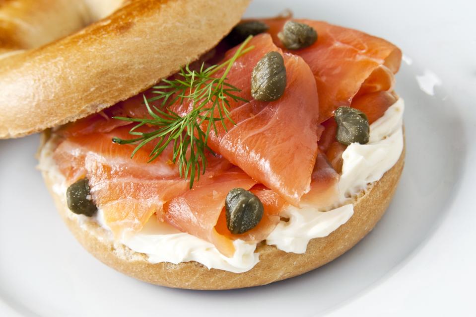 Cream cheese and lox on a bagel with capers and dill