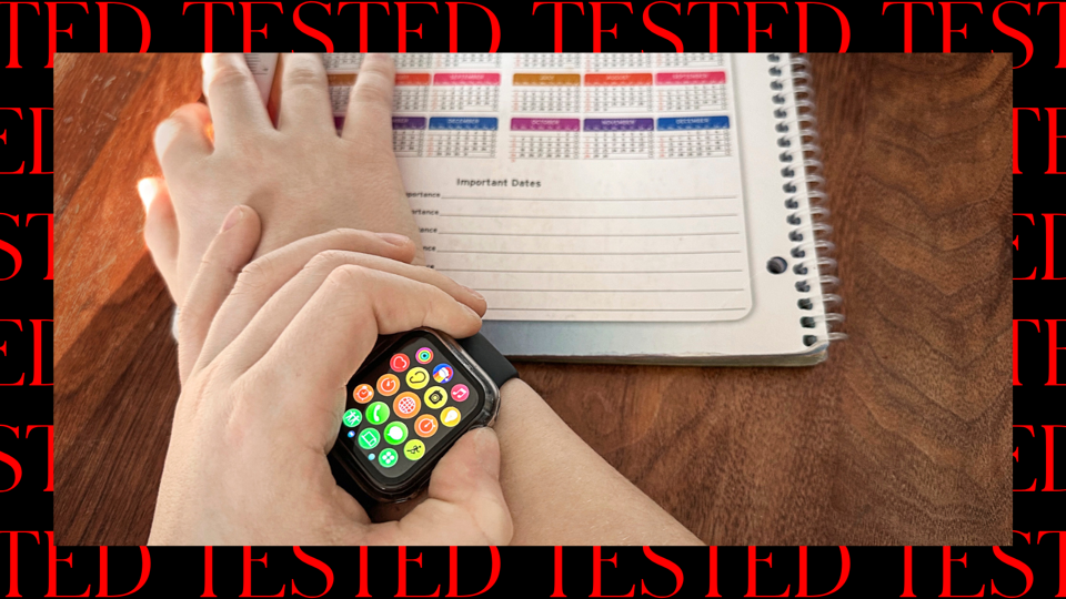 A kid wearing the Apple Watch SE while his hand rests on a table with a planner under it.