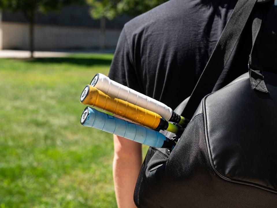 College Student with Squash Racquets