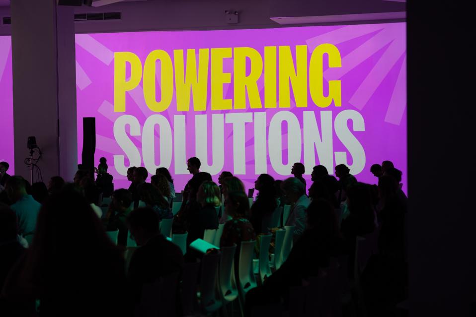 Photo of a wall with the words Powering Solutions projected