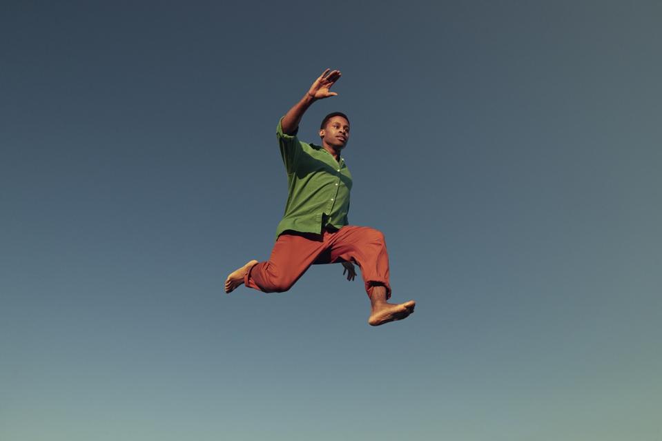 Man jumping in mid-air while doing acrobat