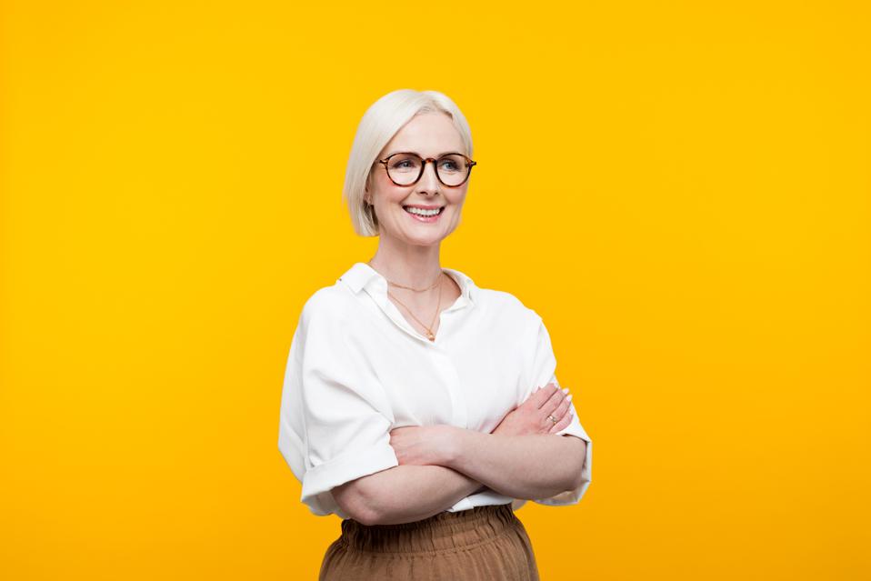 Portrait of happy mature woman thinking about a successful career change at 40