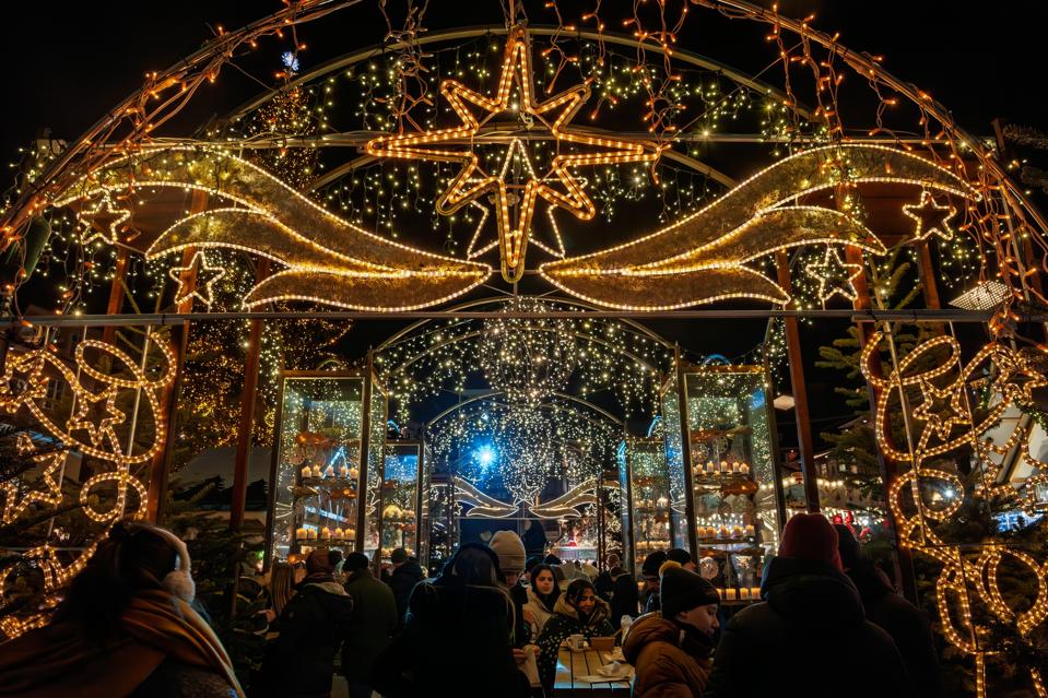 Illuminated decorations at Graz Christmas Market or Graz Weihnachtsmarkt (adventmarkt), highlighting festive holiday lights and vibrant night atmosphere.