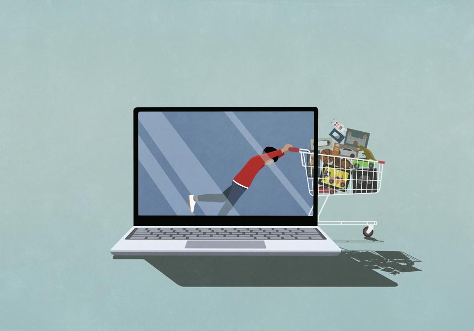 Digital image of a laptop. On the screen is a young person pushing a full shopping cart off the screen and out into the space next to the laptop. E-commerce versus in-person shopping