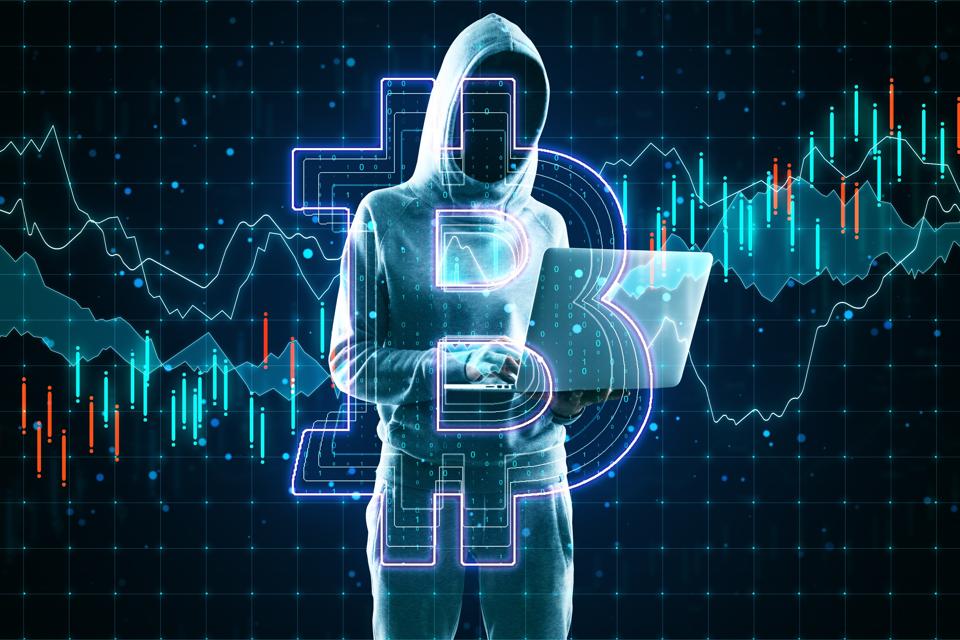 Cryptocurrency and hacking concept with no face hacker with laptop and bitcoin sign.