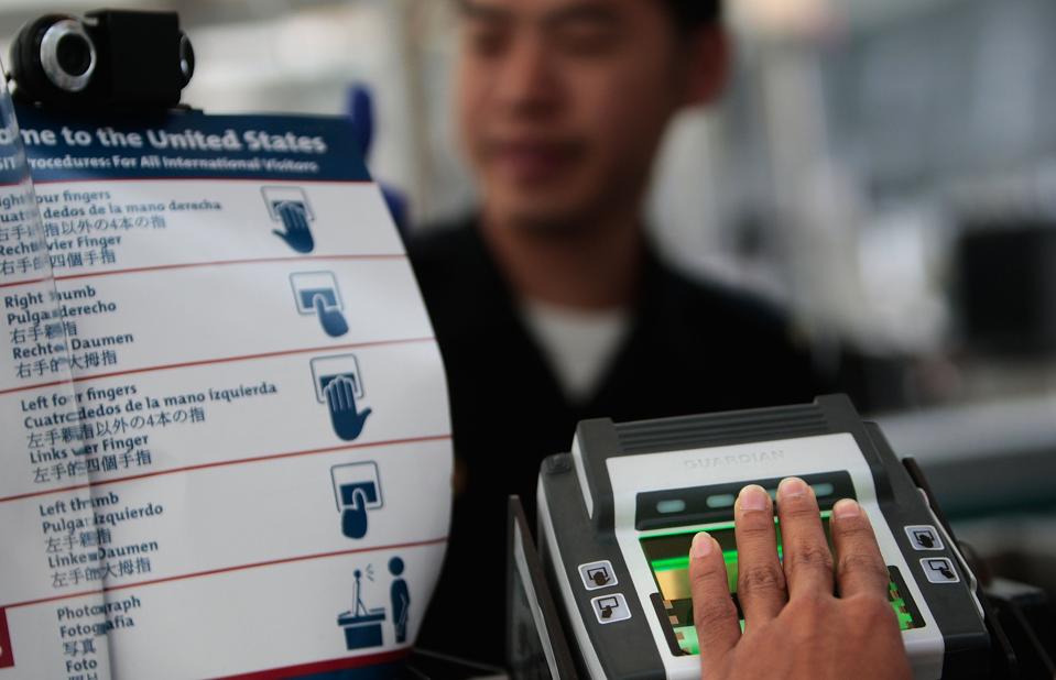 Someone scanning his or her fingerprints at Newark International Airport on August 24, 2009 (Photo by Chris Hondros/Getty Images)