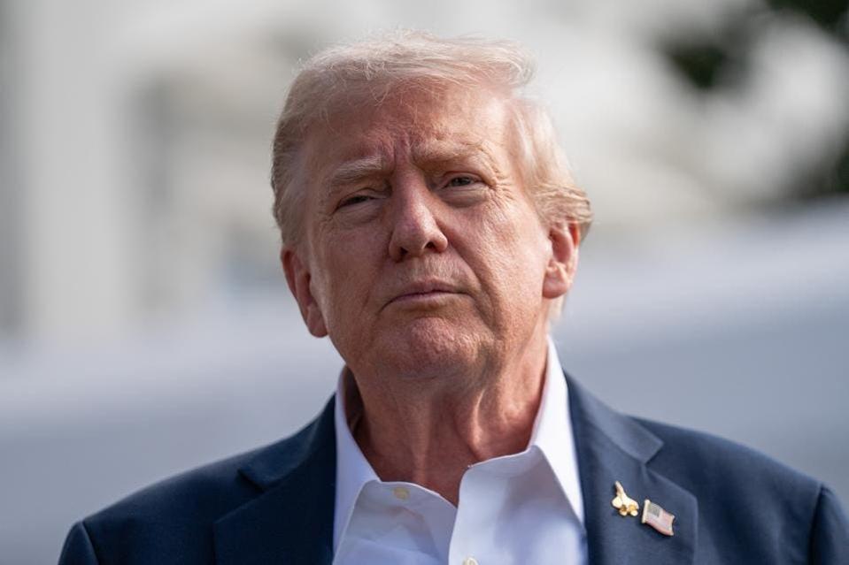 President Donald Trump looks on