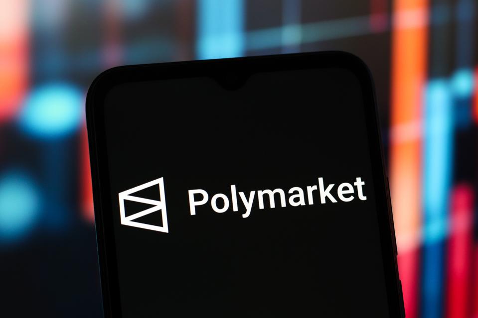In this photo illustration, the Polymarket logo is seen...