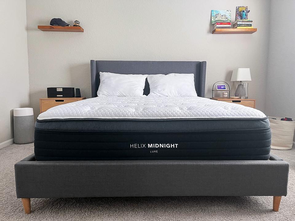 The Helix Midnight Luxe Mattress on a gray bed frame. 