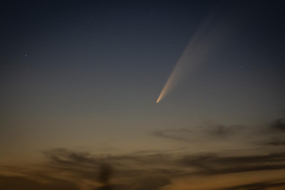 The Comet C/2024 G3 (Atlas) is visible over a rural area...