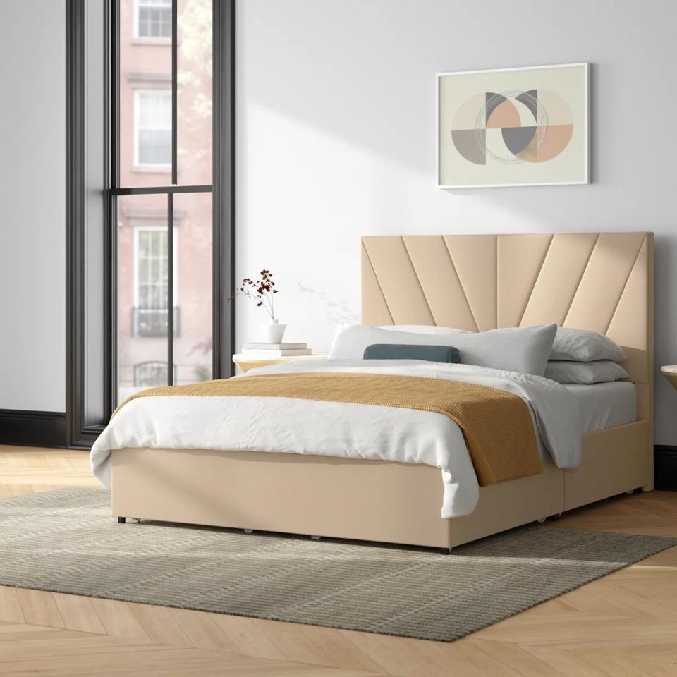 The Mercury Row Cletus Upholstered Storage Bed in a show room.