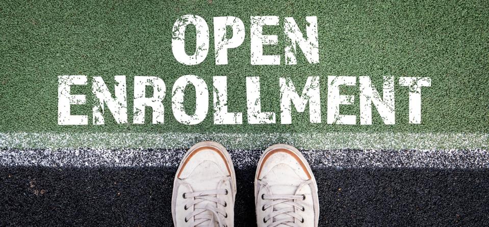 Open Enrollment concept. Starting line and shoes on a green and black background