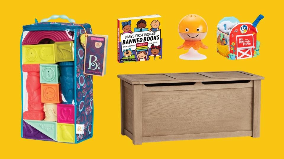 A toy box, blocks, a book and other baby toys on a yellow background