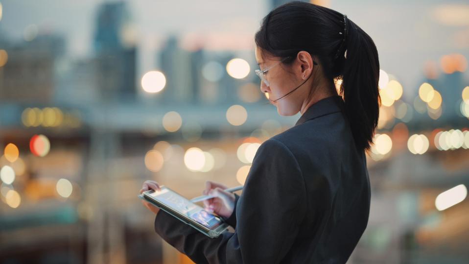 Global investor coding business AI tools on a digital tablet  showcasing the creation of software solutions for enterprisesuse of AI in business 2025