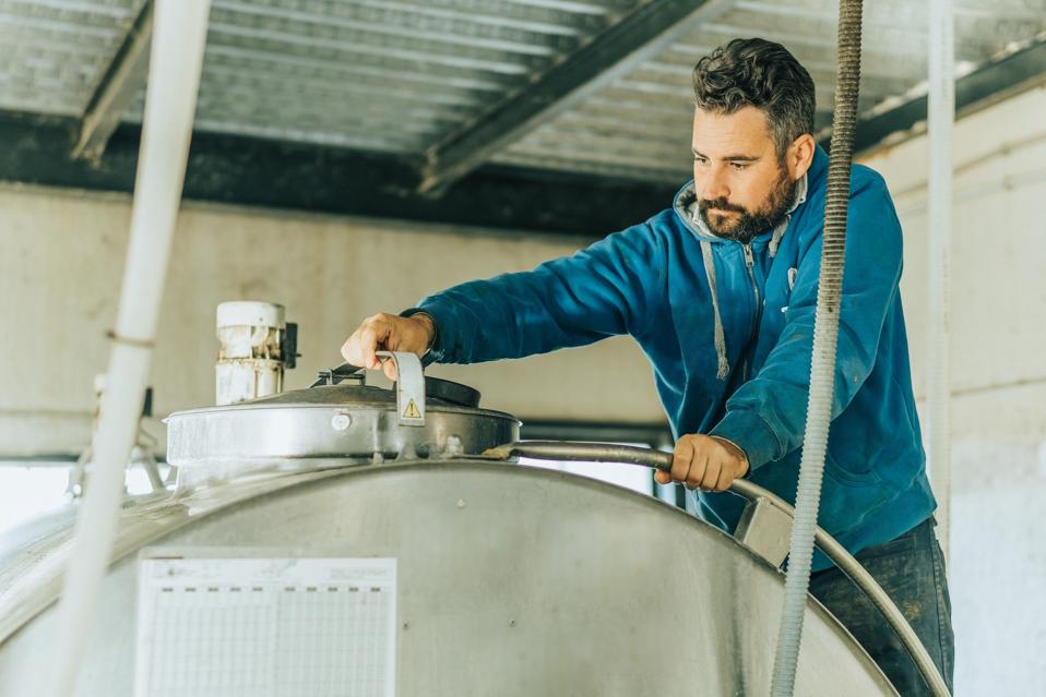 man closing the lid of a milk container