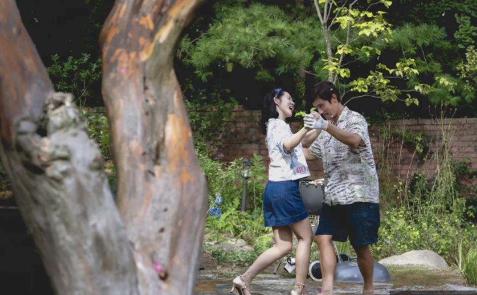 A couple dancing in their garden