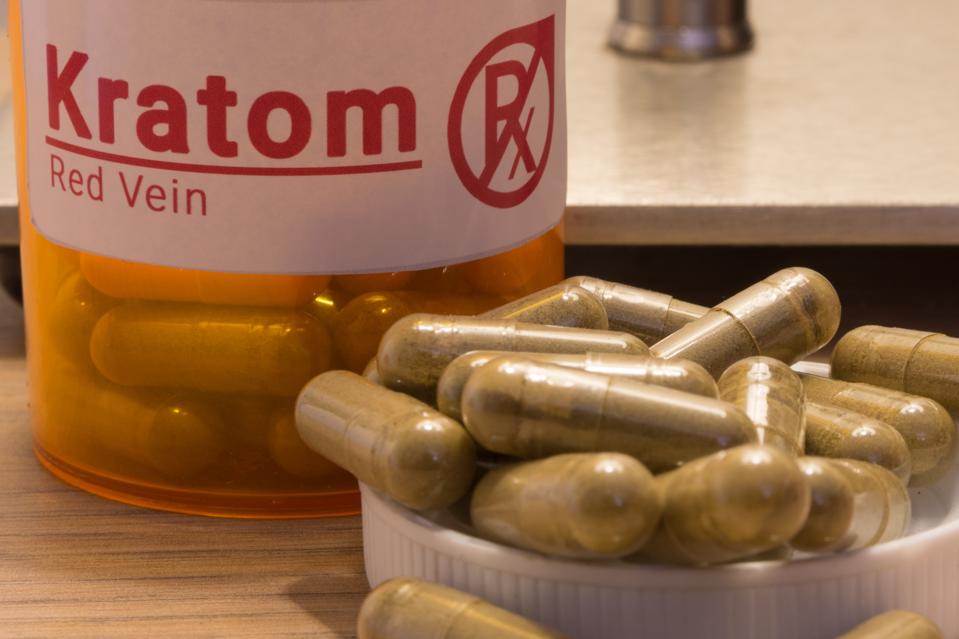 Kratom pills with a faux prescription logo.