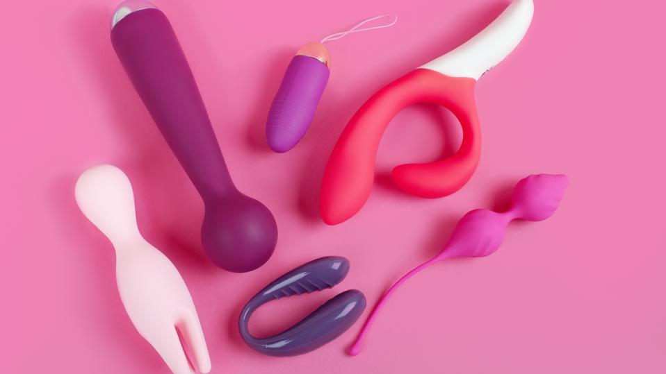 Silicone sex toys on a pink background. Erotic toy for fun. Sex gadget and masturbation device.