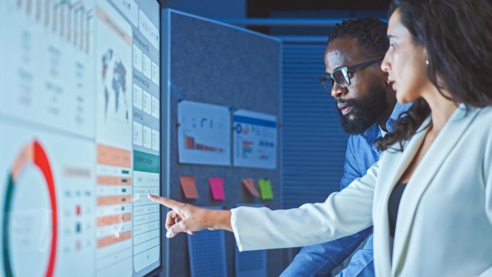 Data analytics team meeting at night.