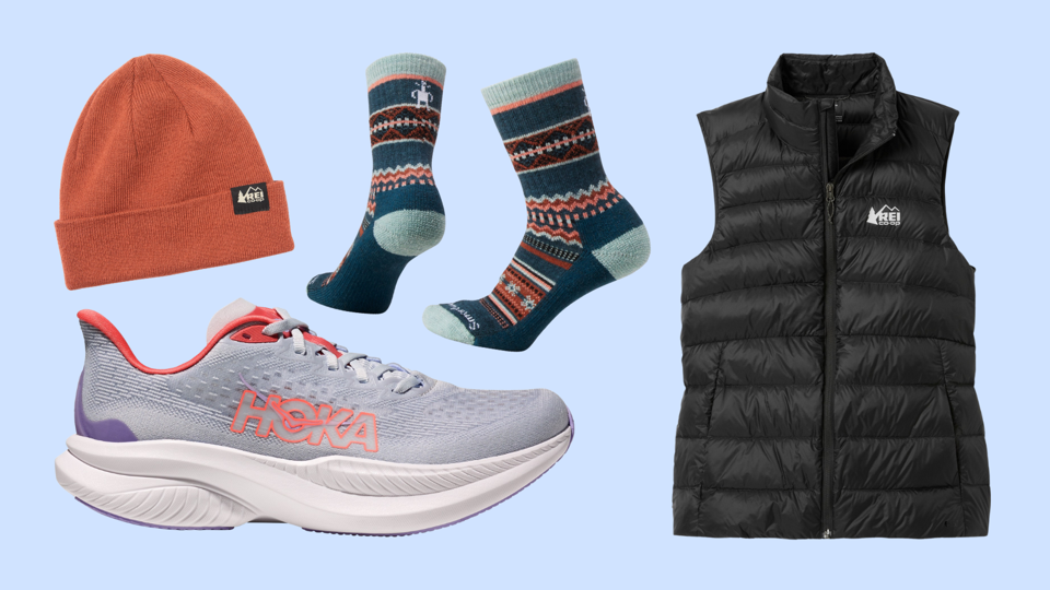 Collage of a Hoka sneaker, black REI Co-op vest, orange hat and Smartwool socks on blue bg.