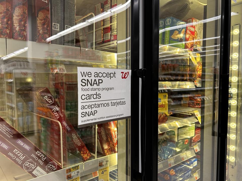 Bilingual sign on door of frozen food aisle, We accept SNAP food stamp cards, Walgreens, Queens, New York