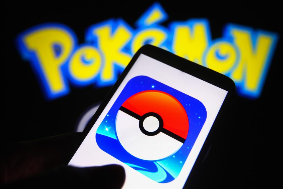 Pokémon Go logo is seen on a smartphone and a pc screen. 