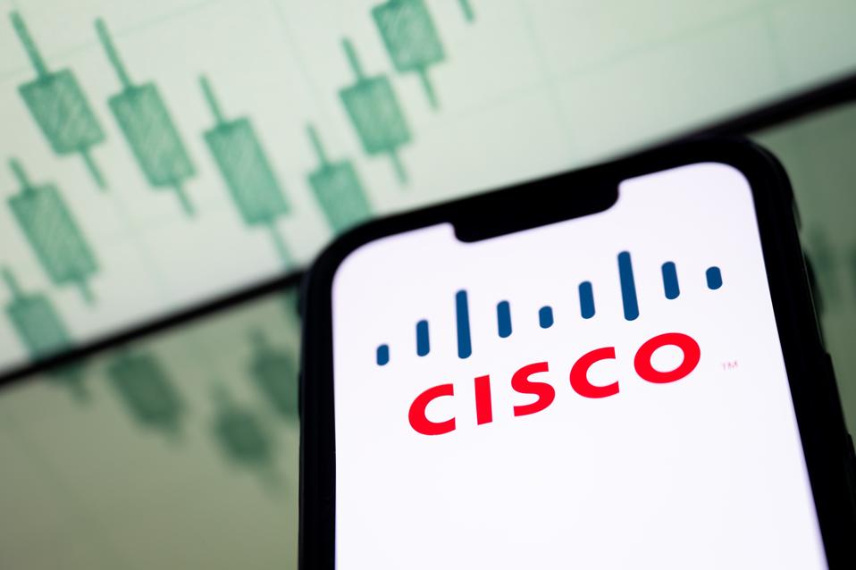In this photo illustration, a Cisco logo seen displayed on a...